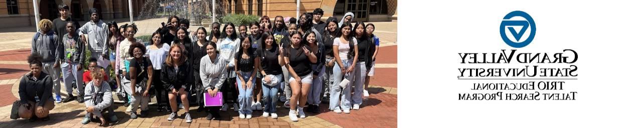 Students pose in front of a fountain